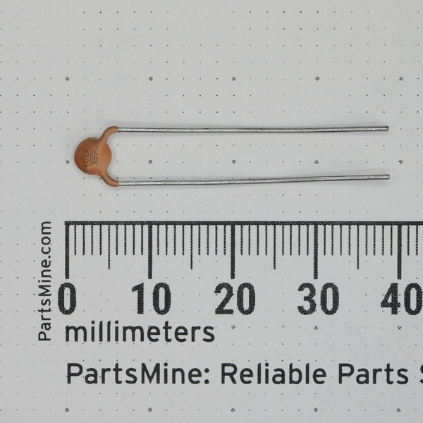 Motorola 21-82187B14 ceramic disc capacitor alongside a metric ruler.