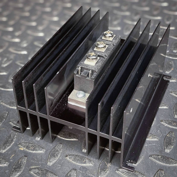International Rectifier IRKT57/10 module mounted on black finned heatsink.