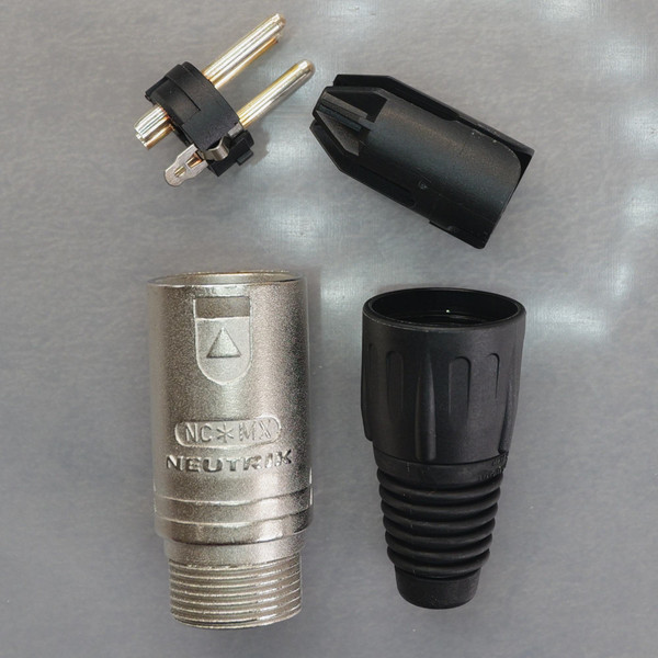 Disassembled components of a Neutrik NC*MX 3-pin male XLR connector.