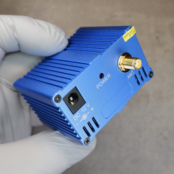 Angled view of v-ARC Systems 1WTX-2470 showing 12V DC power input, power LED, and antenna port.