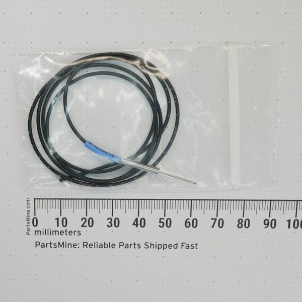 Keyence FU-32 fiber optic sensor in a clear plastic bag next to a millimeter scale.
