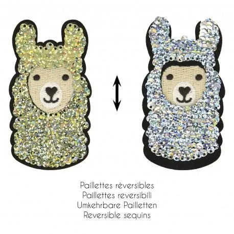 It’s a photo of two playful llama‑shaped sequin patches. Each patch shows a cute llama face with stitched black eyes, a nose, and a small smile. The bodies are covered in reversible sequins—one shimmering gold, the other bright silver. A double‑headed arrow between them suggests the sequins can be flipped to switch between the two colors. Beneath the patches, text in several languages explains that the sequins are reversible. The whole image has a fun, crafty feel, highlighting the color‑changing effect of the sequins.