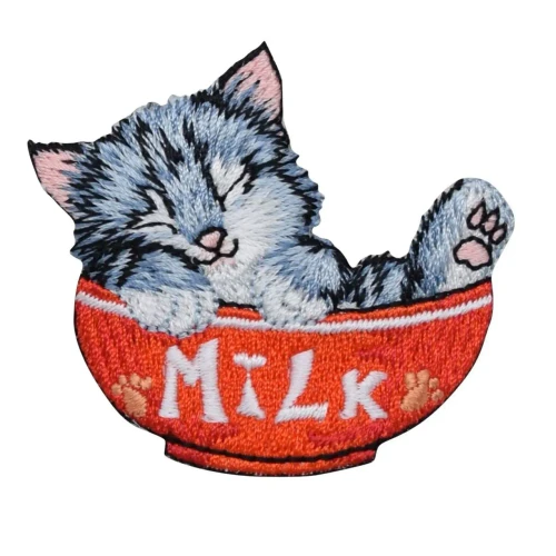 It’s a small embroidered patch featuring an adorable gray‑and‑white kitten curled up and fast asleep inside a bright orange bowl. The kitten has soft black stripes, pink ears, and a tiny pink nose, giving it a sweet, cozy look. The bowl is stitched with the word “MILK” in white letters, flanked by two little paw prints. The whole design has a playful, handmade charm—cute, colorful, and perfect for adding a bit of whimsy to a jacket, bag, or craft project.
