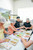 Group of teenagers laughing while decorating giant chocolate freckles during The Treat Factory's DIY Giant Chocolate Freckle Experience in Berry NSW.