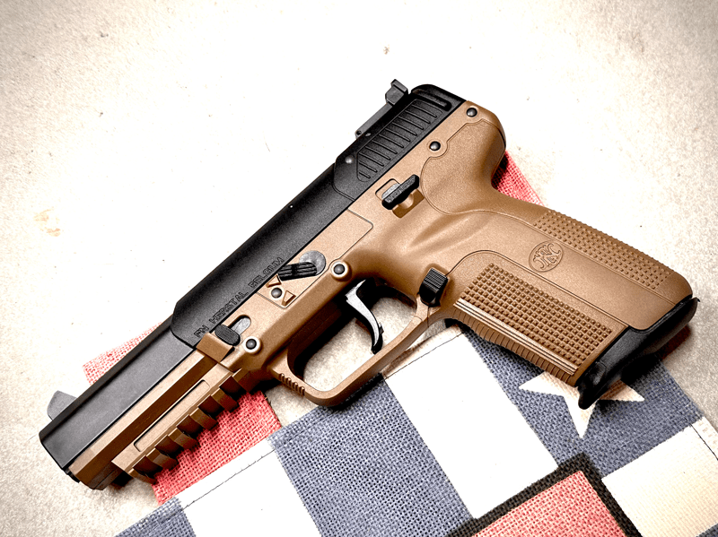FN fiveSeven pistol on gun mat