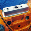 Placed in original tank compartment under hood.
