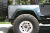 Side view of polished corner guard with factory TJ rear flare and 37" tires