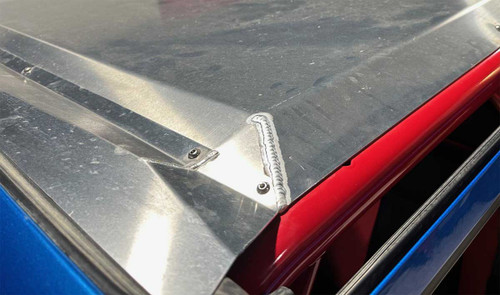 Close up of how filler piece for aluminum roof seals the gap between windshield and roof