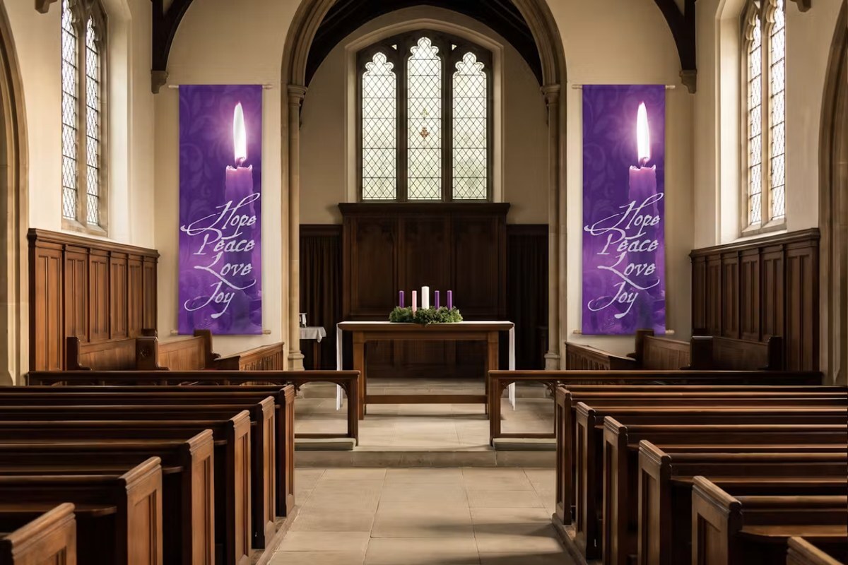 Two purple Hope Peace Love Joy Advent candle banners hanging on either side of the altar with an Advent wreath
