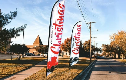 Celebrate Christmas feather flags along the road outside a church