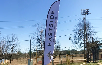 Custom Eastside church feather flag outside a church