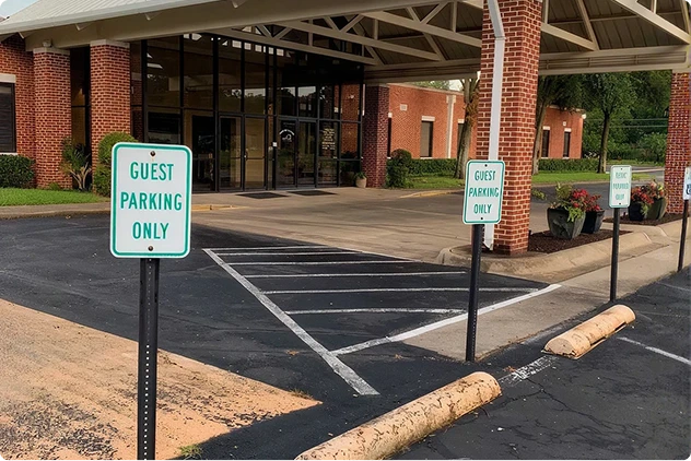 Aluminum guest parking signs outside a building