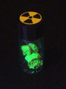 1 Gram Autunite in a Sealed Vial illuminated by UV light showing bright green fluorescence