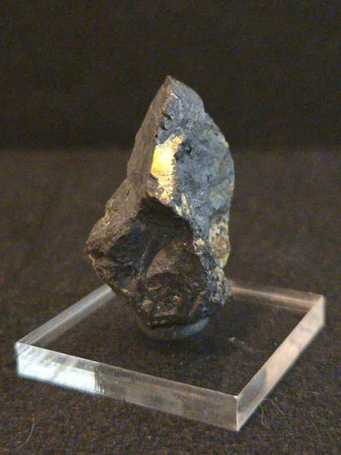 Uraninite - Deer Park Mine, North Carolina, USA  on acrylic mount indoor light