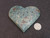 carved Blue Apatite Crystal under indoor light - size comparison to penny top view