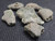 six piece Trinitite lot on display under indoor light
