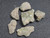 six piece Trinitite lot on display under indoor light