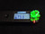 7 Gram Autunite Crystal Formation on Matrix  displayed under 365nm UV light being measured with the Radiacode 102