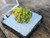 4.8 Gram Autunite Crystal in Perky Box under outdoor light
