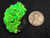 21 Gram Autunite on Quartz under 365nm UV light  size comparison to copper penny top view