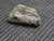 1.5 Gram Trinitite sample with black inclusions under indoor light