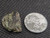 1.5 Gram Trinitite sample with black inclusions under indoor light size comparison to steel penny top view