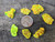 7 Piece Autunite Lot under outdoor light demonstrating daytime fluorescence size comparison to copper penny top view