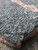 black bubbly botryoidal uraninite under outdoor light