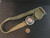 Model 1949 Wrist Compass under indoor light size comparison to copper penny top view