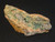 yellow/brown Parsonsite, tan Kasolite & green Metazeunerite on matrix displayed under indoor light