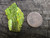 Green autunite crystal formation under   outdoor light size comparison to copper penny bottom view