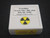 showing how the specimen is stored in a labeled display case and radioactive warning tape - bottom view