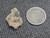 vitreous trinitite under indoor light size comparison to copper penny bottom view