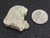 vitreous looking trinitite 5.3 gram specimen under indoor light size comparison to steel penny top view