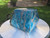 polished blue apatite crystal sculpture under outdoor light