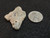 This vitreous looking trinitite specimen size comparison to steel penny top view