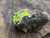Bright yellow/green autunite crystals o matrix demonstrating daytime fluorescence under outdoor light