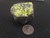 drab looking yellow-green autunite crystals on smoky quartz matrix size comparison to copper penny top view under indoor light