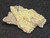 drab yellow/brown Andersonite with Schröckingerite on sandstone matrix under indoor light