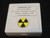 bottom view of display case showing label and yellow and black round trefoil symbol