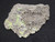 Bright yellow Andersonite & Schröckingerite on grainy Sandstone matrix under indoor light