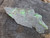 Bright yellow Andersonite & Schröckingerite, and white Metamunirite on sandstone matrix under outdoor light
