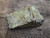 close in view showing Bright yellow Andersonite globules, few green Schröckingerite spatters  and white Metamunirite  globules on grainy sandstone matrix under outdoor light