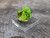 bright green green Autunite crystal formation displayed under outdoor light