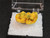 yellow orange autunite crystal formation in perky box under indoor light