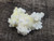 yellow boltwoodite on white gypsum matrix under outdoor light