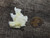 yellow boltwoodite on white gypsum matrix under outdoor light size comparison to copper penny Bottom view