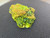 Bright green and reddish yellow green autunite under outdoor light rotated
