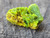 Bright yellow and green gnarly autunite crystal formation under outdoor light