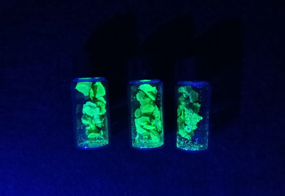 Lot of Three Sealed Vials Each Containing 1 Gram Autunite Fragments displayed under 365nm UV light